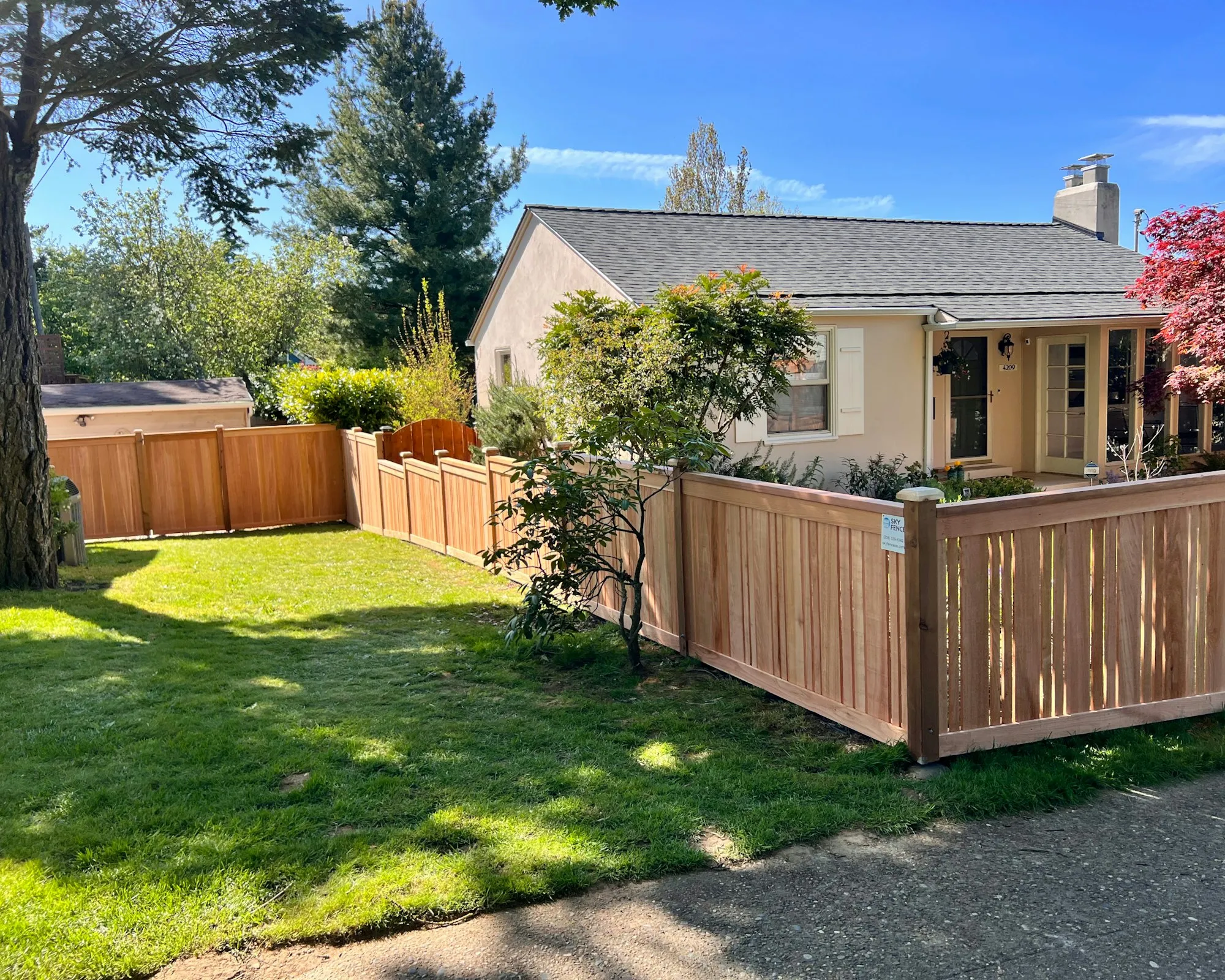 Cedar board fence around the front yard of a single-storey house
